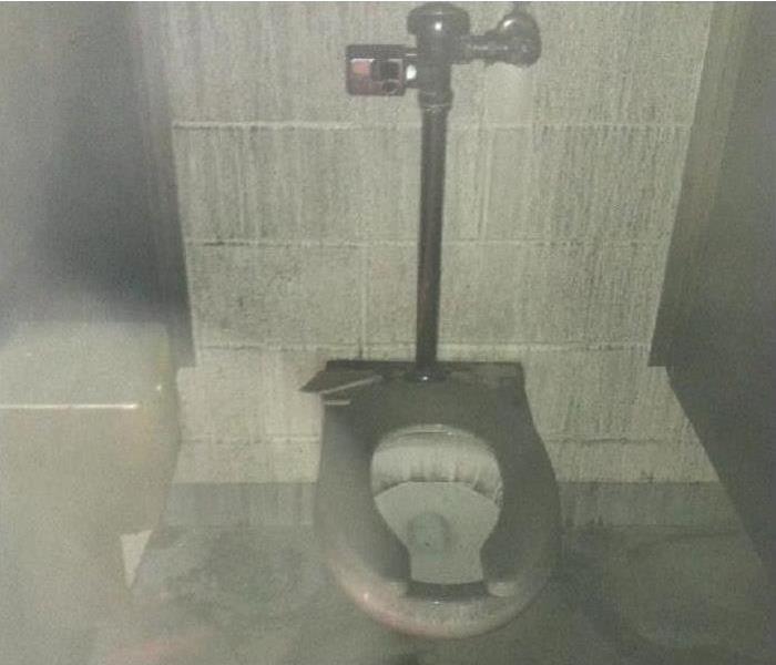 Commercial Fire Bathroom stall covered in black soot