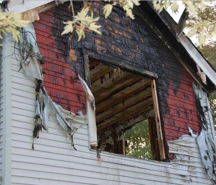 Side of house with window burnt out 